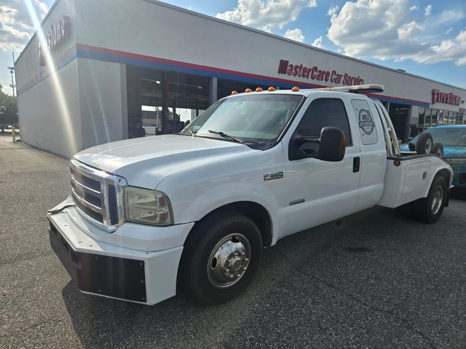 White Ford F-350 Super Duty tow truck with Auto Assistance & Towing branding, Orlando roadside and towing service vehicle